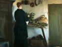 Kitchen interior. The artists wife arranging flowers